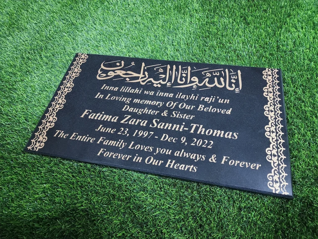 black granite islamic gravestone with golden inscription