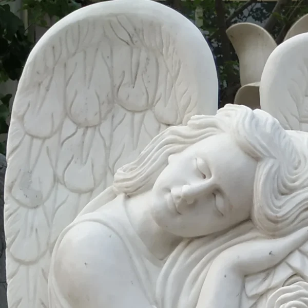 white marble headstone with angel sculptured